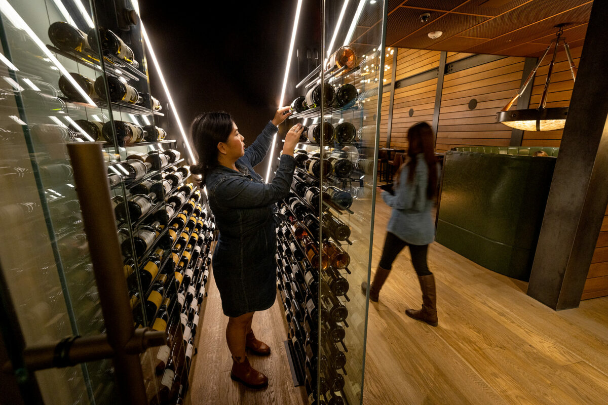 A glass showcase of fine wines under the stairs at Goodnight’s Prime Steak + Spirits Friday, August 11, 2023 on the square in Healdsburg. (Photo John Burgess/The Press Democrat)