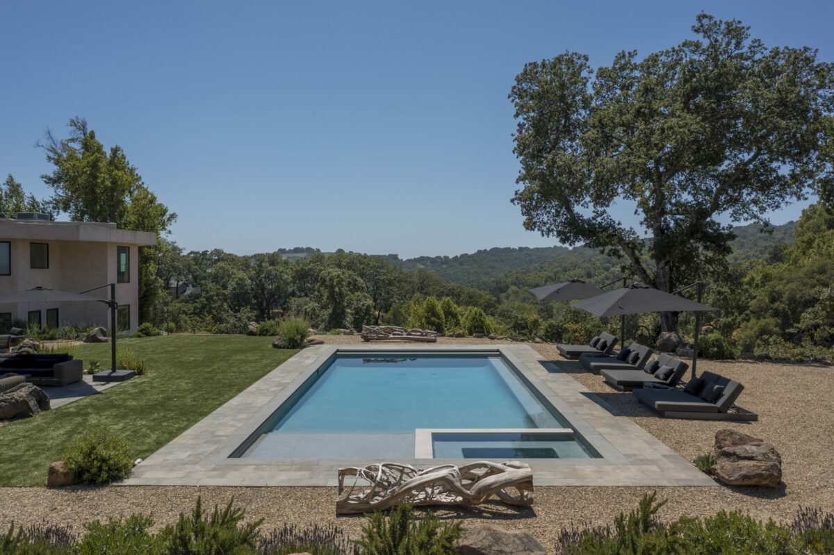 Wood root furnishings plus slate loungers are inspired accents to the pool area. (Provided by Caroline Sebastiani / Sotheby’s International Realty)