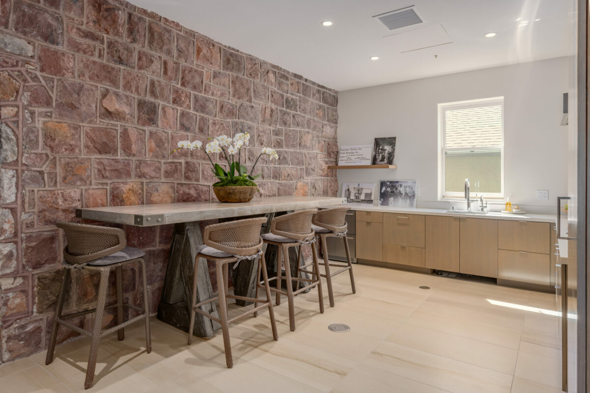 Modern design elements in this kitchen blend well with the exposed original stone wall. (Paul Rollins for Sotheby’s International Realty)