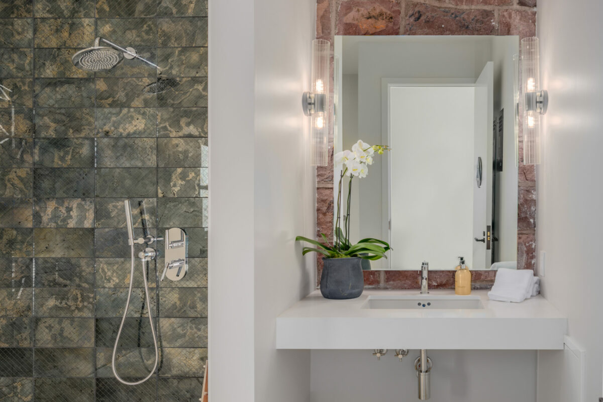 More uncovered elements of the original building serve as an interesting accent in the bathroom. (Paul Rollins for Sotheby’s International Realty)