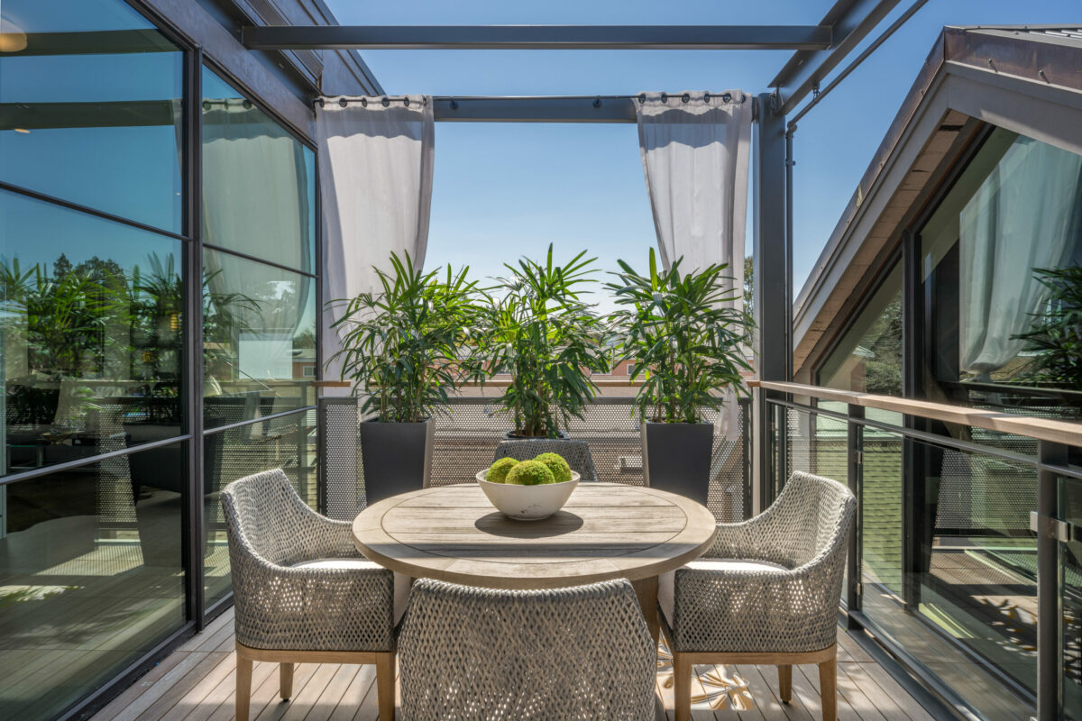 A second story porch is decorated to offer both privacy and views. (Paul Rollins for Sotheby’s International Realty)