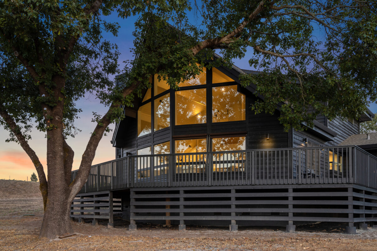 A Santa Rosa A-frame home on a tree-dotted lot that overlooks a vineyard is currently listed for sale for $2.75 million. The offer includes a second parcel and a second home in need of renovation. (Open Homes Photography)