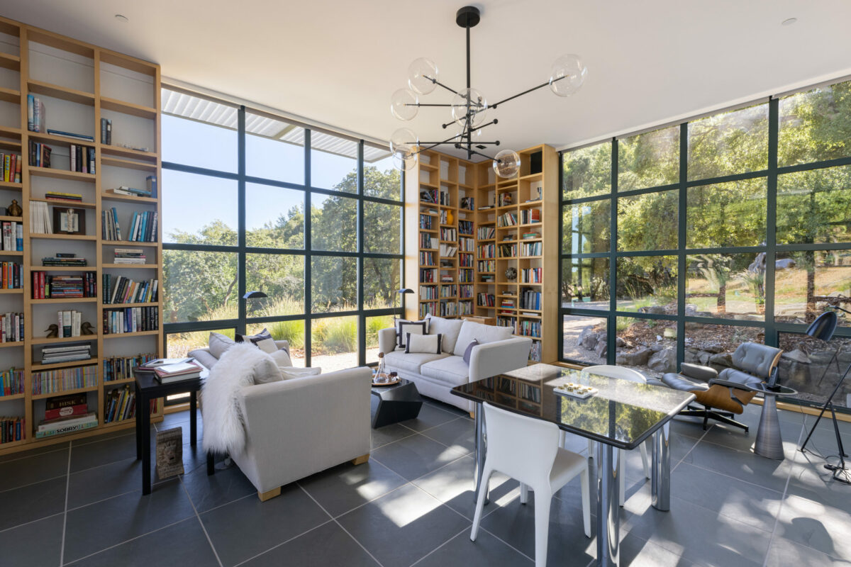 The modern library enjoys wood built-ins, views, and lots of light. (Steven Magner)