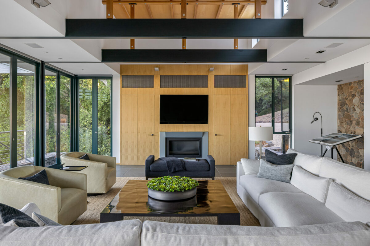 The home features walls of windows with mechanized shades. Stone accents were sourced from the property during excavation. (Steven Magner)