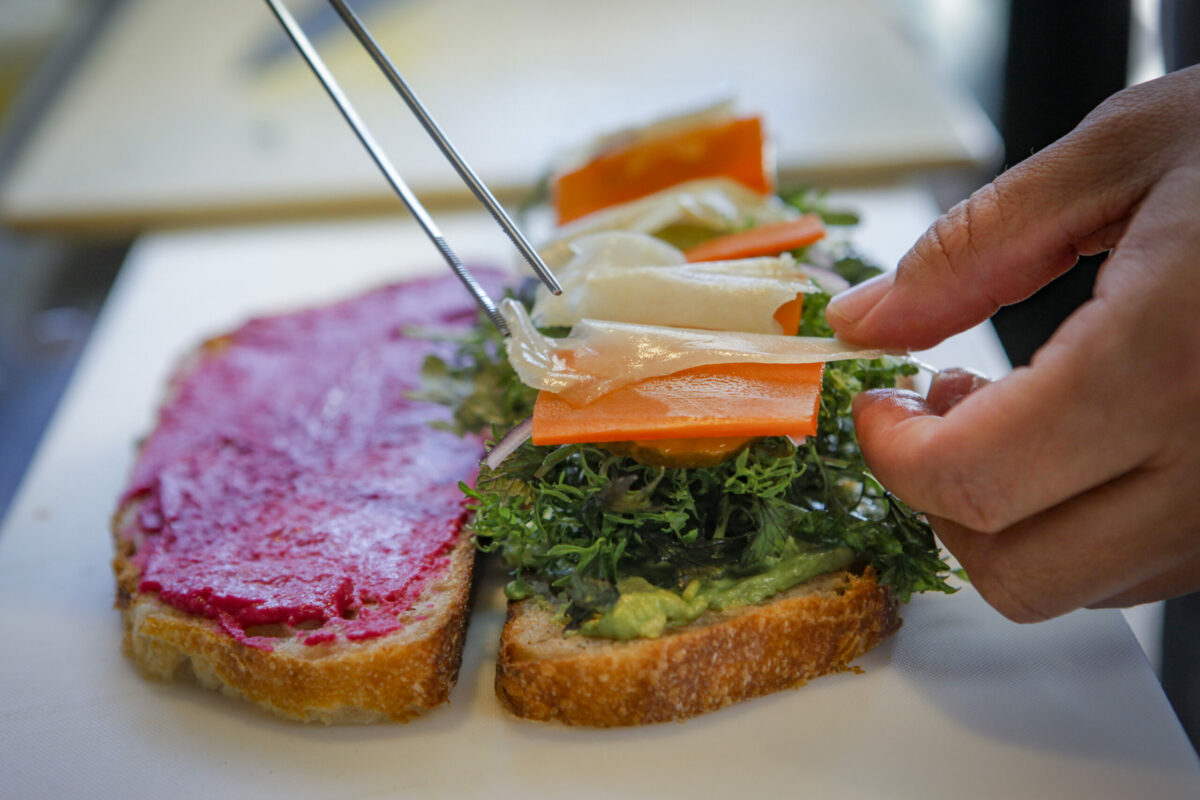 Raul Lopez builds the popular Helen Putnam sandwich. (Crissy Pascual/Petaluma Argus-Courier)