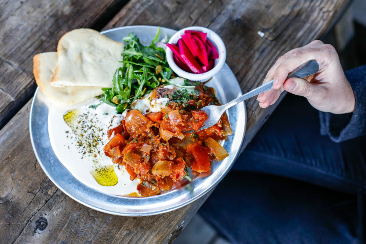Shakshuka — a Middle Eastern dish of poached egg, zesty tomato sauce, onions and a side of hummus and puffy pita bread — at Lightwave Coffee and Kitchen in Monte Rio. (Daniel Beck/Sonoma County Tourism)