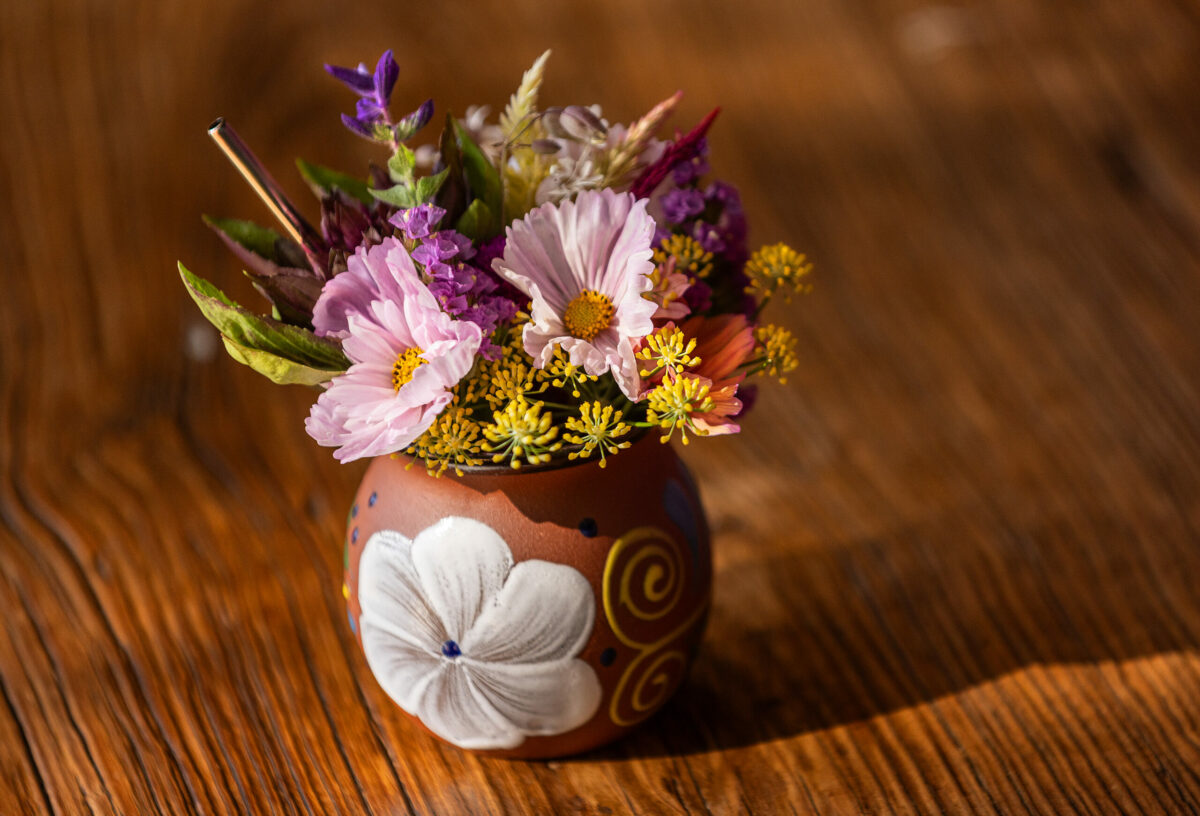Guests at Second Story are greeted with a drink drawn through a bouquet of flowers with a stainless straw at the new upstairs vegan restaurant at Little Saint in Healdsburg September 8, 2023. (John Burgess/The Press Democrat)