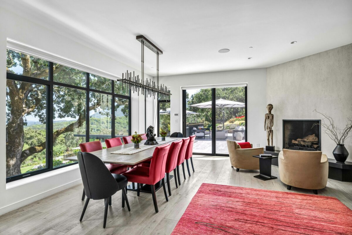 The dining area and fireplace. (SeaTimber Media / Sotheby’s International Realty)