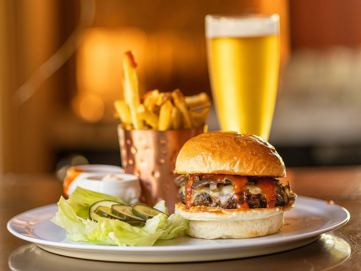 The Madrona Burger with roasted onions, white Cheddar cheese, spicy ketchup and beef fat fries from the weekend brunch menu at The Madrona in Healdsburg, Friday, July 14, 2023. (John Burgess / The Press Democrat)