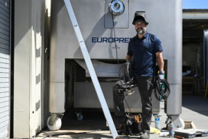 Harvey Gonzalez, 47, working on a Europress at Punchdown Cellars in Santa Rosa, Calif. on July 11, 2023. (Photo: Erik Castro/for Sonoma Magazine)