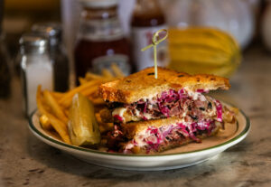 NY Style Pastrami Sandwich with home made sauerkraut and half sour dill pickle with fries from the new J & M’s Midtown Café October 23, 2023 in Santa Rosa. (Photo John Burgess/The Press Democrat)