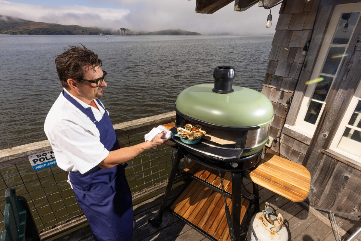 Chef Chris Consentino grills up Nick’s BBQ’D Oyster in the oven at the end of the dock on Tomales Bay Monday, September 18, 2023 at Nick’s Cove Restaurant. (Photo John Burgess/The Press Democrat)
