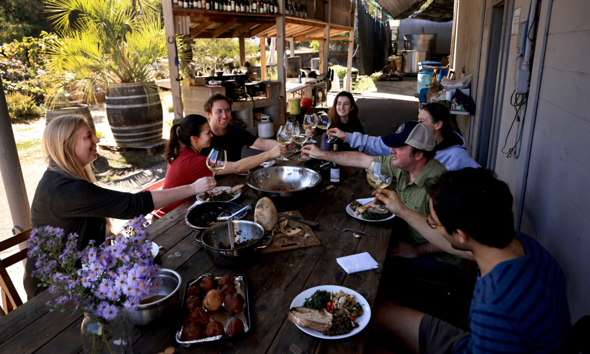 Radio-Coteau employees Stephanie French, Elena Gleed, Bryan Lairmore and Davida Ebner, are treated to lunch by by Eric Sussman as he toasts to the harvest, the meal was prepared by Harry DiPrinzio,right, Wednesday, Sept. 29, 2021 near Graton. (Kent Porter / The Press Dmocrat) 2021
