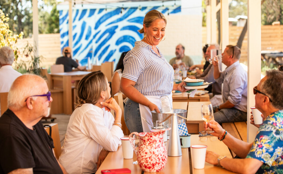 Valley Swim Club server Nikki Watkins, who previously worked at the Delicious Dish on Arnold Avenue in the same location in Sonoma, talks with guests, Tuesday, Oct. 3, 2023. (John Burgess / The Press Democrat)