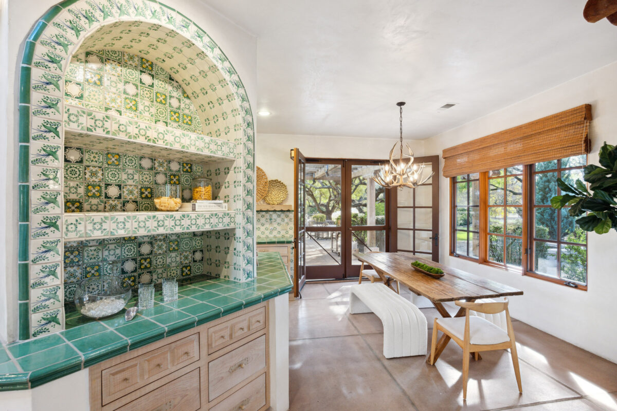 The home has a modern and minimalist feel that is punctuated by spots of rich pattern and color, like this tiled countertop and shelf. (Open Homes Photography / Sotheby's International Realty)