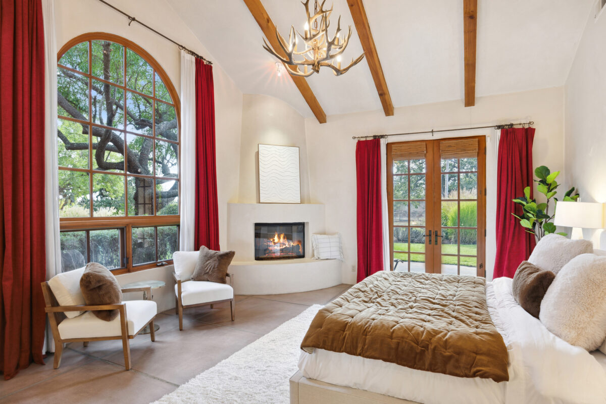 Bright accents, like these red curtains, can be found throughout the home. (Open Homes Photography / Sotheby's International Realty)
