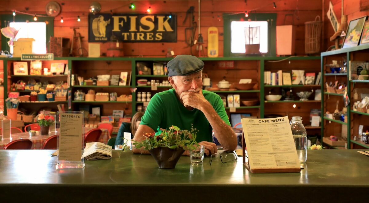 Charles Brown takes a break for lunch as his daughter, Jimtown Store owner Carrie Brown and her staff prep meals for the day, Thursday, July 18, 2019. (Kent Porter / The Press Democrat) 