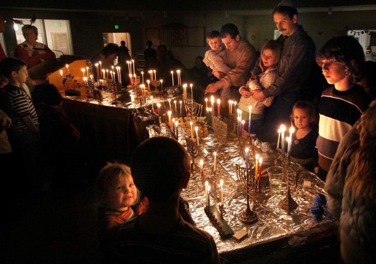 Members of Congregation Shomrei Torah gather to light candles in menorahs they brought to the Santa Rosa synagogue for the second night of Hanukkah. (The Press Democrat)