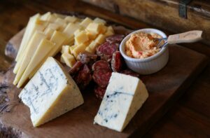 A cheese plate from Point Reyes Farmstead Cheese Co. with Point Reyes Toma, aged Gouda, salami, pimento cheese, Point Reyes Bay Blue and Original Blue cheeses. (Christopher Chung/The Press Democrat)