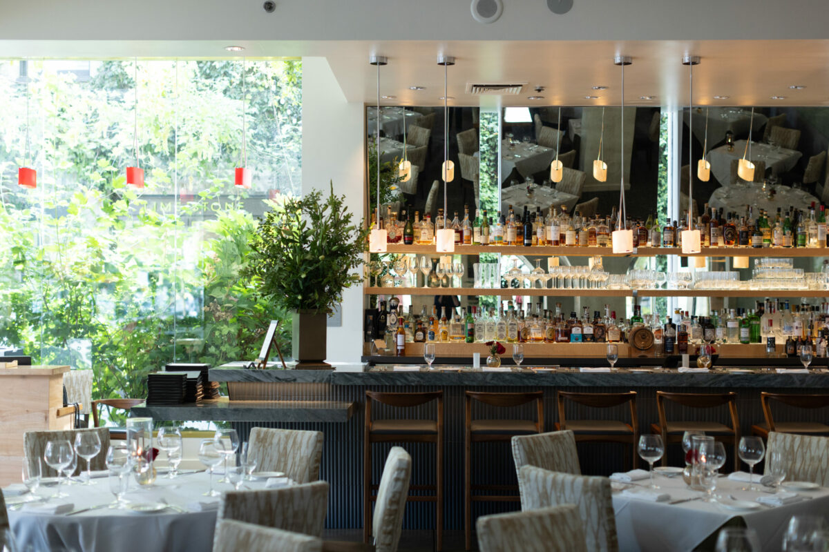 Dry Creek Kitchen’s redesigned bar in Healdsburg on Sept. 21, 2023. The new look includes a marble surface, soft lighting from overhead pendants and large mirrors behind the bar. (Paige Green)