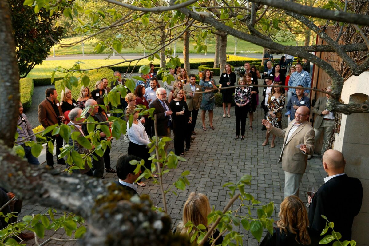 United Way of the Wine Country president and CEO Mike Kallhoff, at right, welcomes guests and makes opening remarks during Reading Between the Vines, a fundraiser for United Way of the Wine Country's education initiatives at Jordan Vineyard and Winery in Healdsburg. (Alvin Jornada / The Press Democrat)