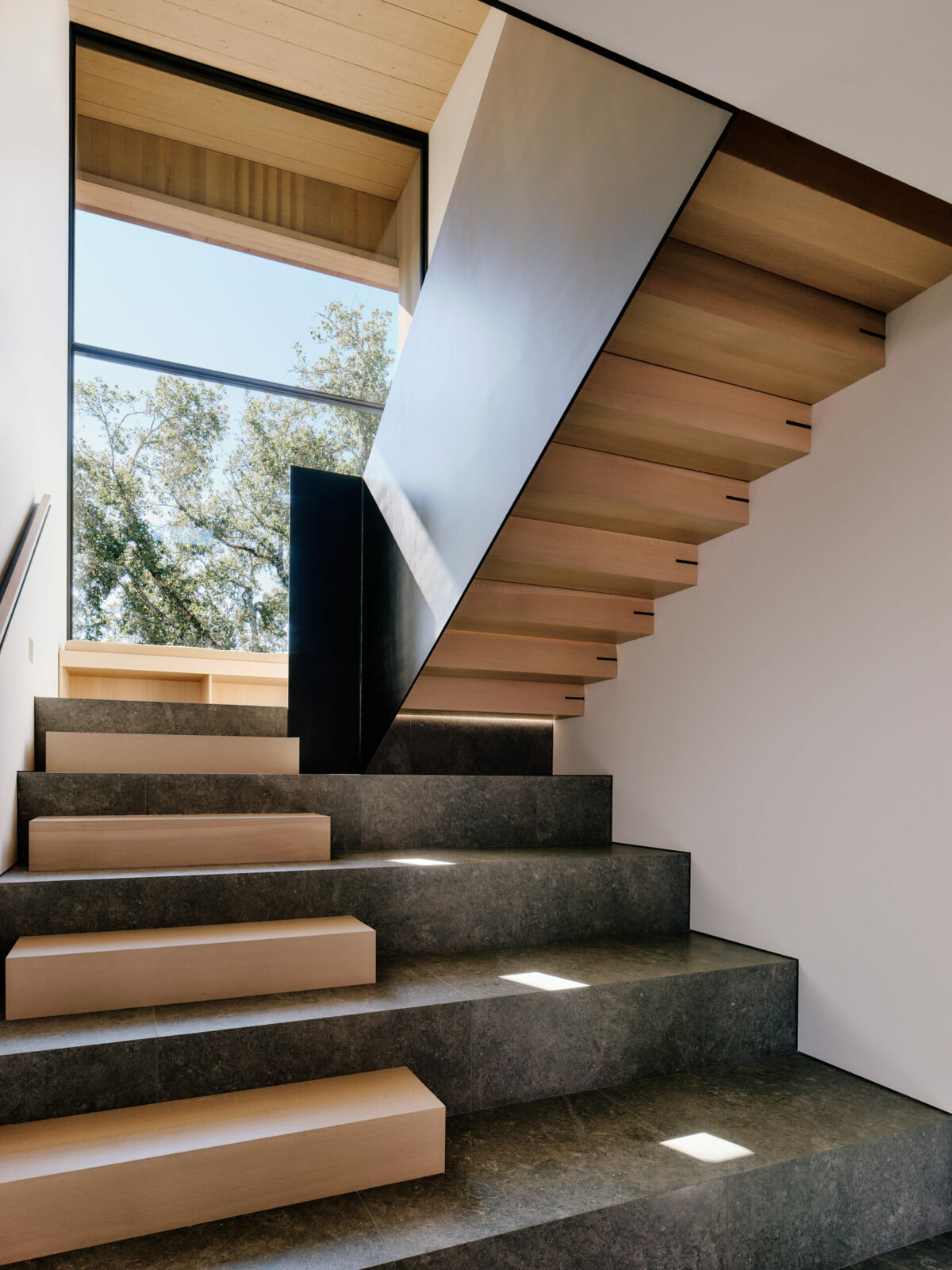 Staircase with an interplay of wood and stone elements. (Joe Fletcher)