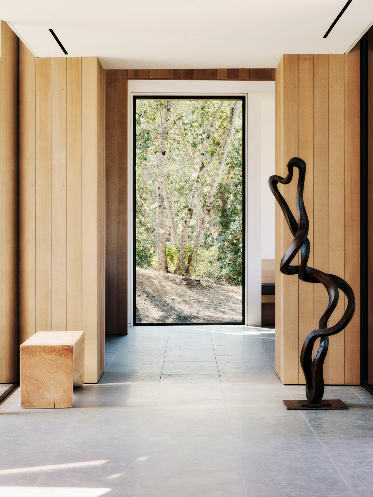 Large entryway window framing tree views. (Joe Fletcher)