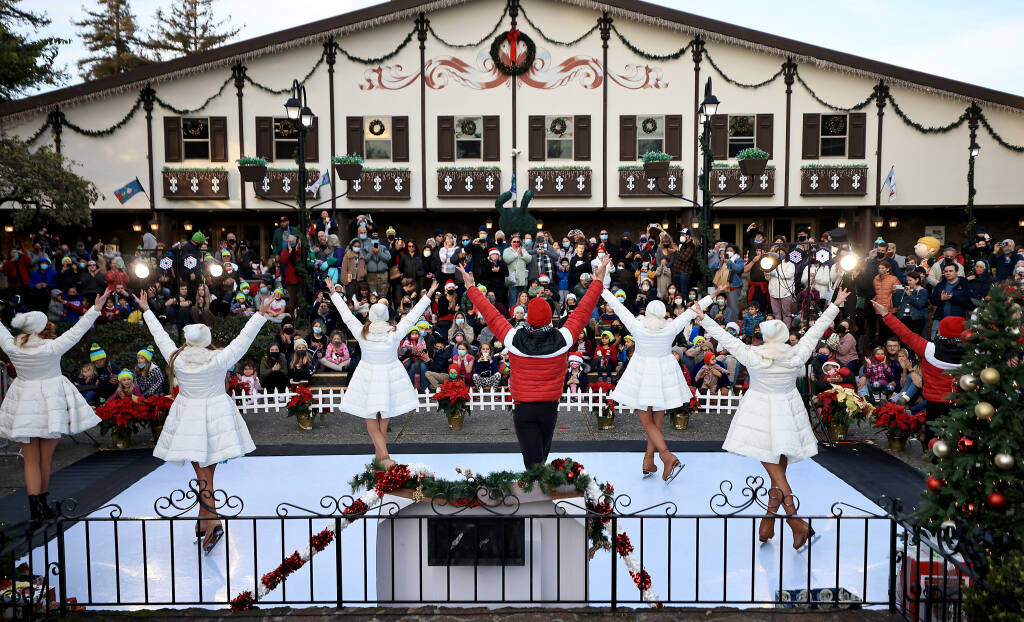 Ice skaters with the Redwood Ice Theatre Company entertain a crowd of several hundred people, Saturday, Dec. 18, 2021 in from of Snoopy's Home Ice. (Kent Porter / The Press Democrat) 2021