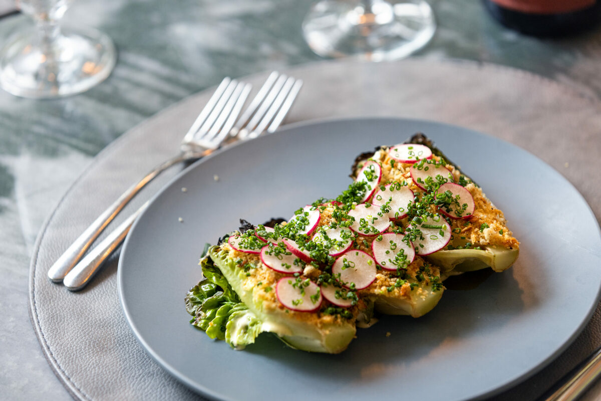 Grilled Russian River Organic’s Gem Lettuce with miso “Caesar” dressing, radish and shallot bread crumbs from the Dry Creek Kitchen Thursday, November 2, 2023 in Healdsburg. (Photo John Burgess/The Press Democrat)