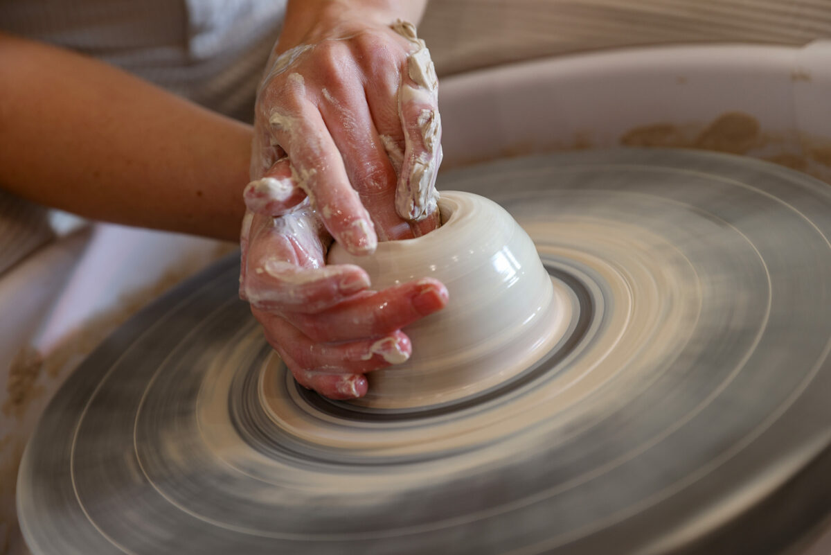 Kaylee Weeks shapes clay into a vase on a pottery wheel at Kickwheel Sonoma in Petaluma, Tuesday, Oct. 3, 2023. (Christopher Chung / The Press Democrat)