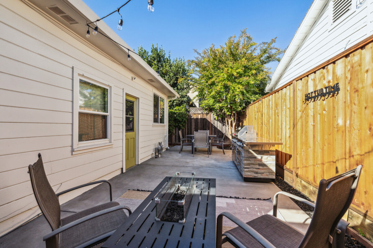 A paved side yard gives spots for gathering, cooking and more. (Open Homes Photography)