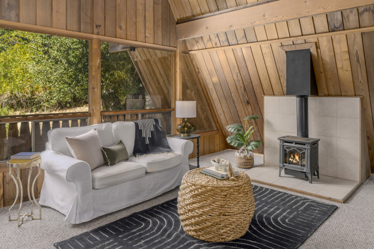 Large windows give ample light and a wood-burning stove caps off the cabin coziness. (Paul Rollins)