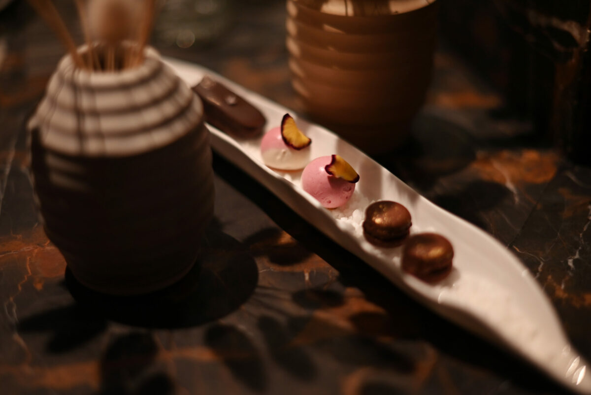 A mignardise of butterfinger, lemon raspberry cheesecake and persimmon caramel macrons at Auro restaurant in Calistoga, Calif. on Thursday, Dec. 8, 2022. (Erik Castro / For The Press Democrat)