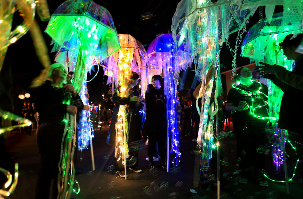 Urban jellyfish, lighted strands in see-through umbrellas are prepped for the WinterBlast Sofa District parade, Saturday, Nov. 4, 2023, in Santa Rosa. (Kent Porter / The Press Democrat)