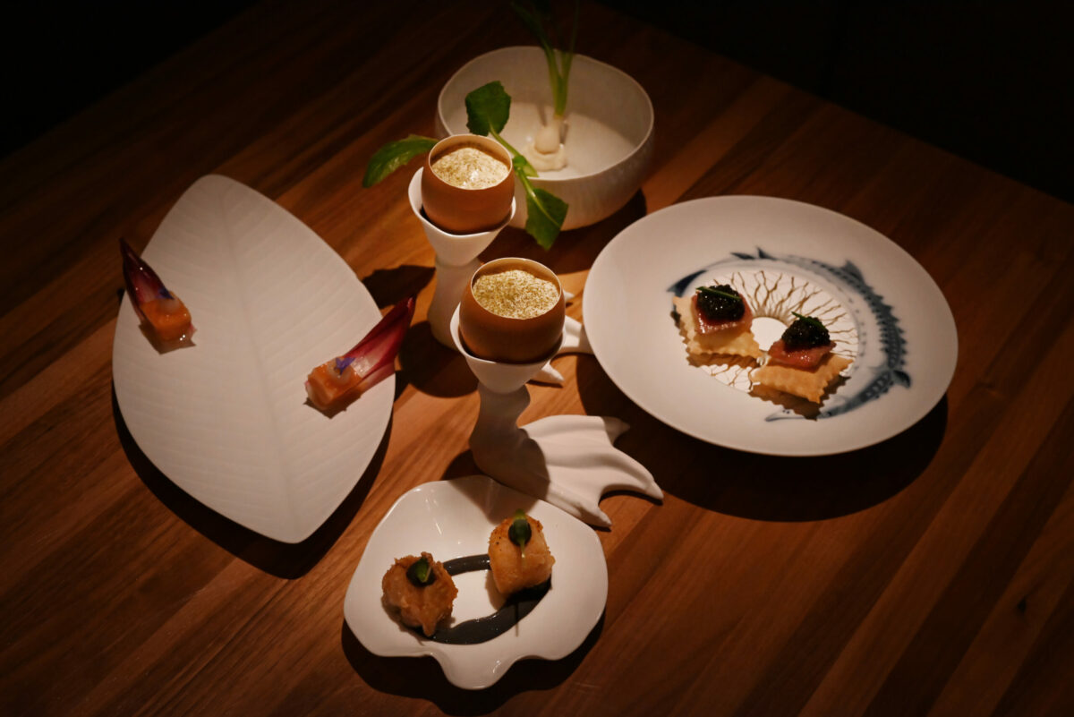 An amuse bouche tasting, from bottom clockwise, Spanish octopus with black yogurt, cherry smoked salmon, Auro golden turnip with truffle Bergamino, American sturgeon caviar and Christmas eggnog served in two egg shells at Auro restaurant in Calistoga, Calif. on Thursday, Dec. 8, 2022. (Erik Castro / For The Press Democrat)