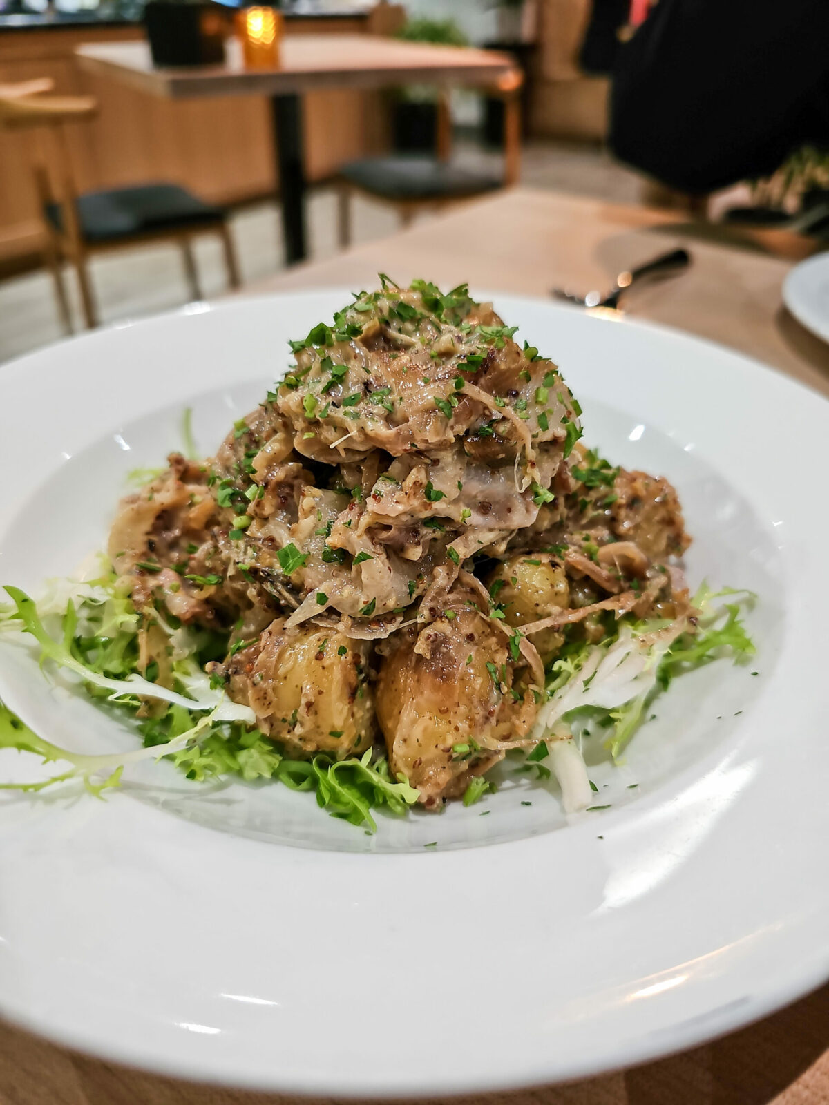 Pork and frisee salad with potatoes at Pascaline Patisserie and Cafe in Santa Rosa. (Heather Irwin/The Press Democrat)