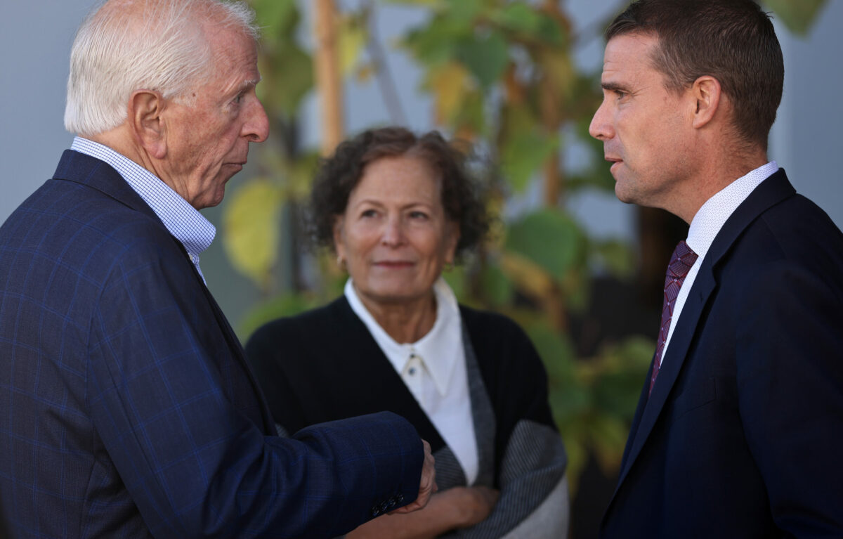 Mike McGuire, the California State Majority Leader, right, and Rep. Mike Thompson of California's 4th Congressional District, finish up a conversation, Friday, Oct. 27, 2023, prior to a celebration of the completion of phase one of Burbank Housing's affordable housing project on land that housed the Journey's End Mobile Home Park, razed in the 2017 Tubbs Fire. In the background is Thompson's wife Jan. (Kent Porter / The Press Democrat) 