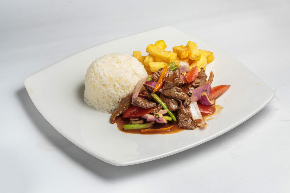 Peruvian food "lomo saltado":A salted beef with tomatoes, onion, fried potatoes and rice.