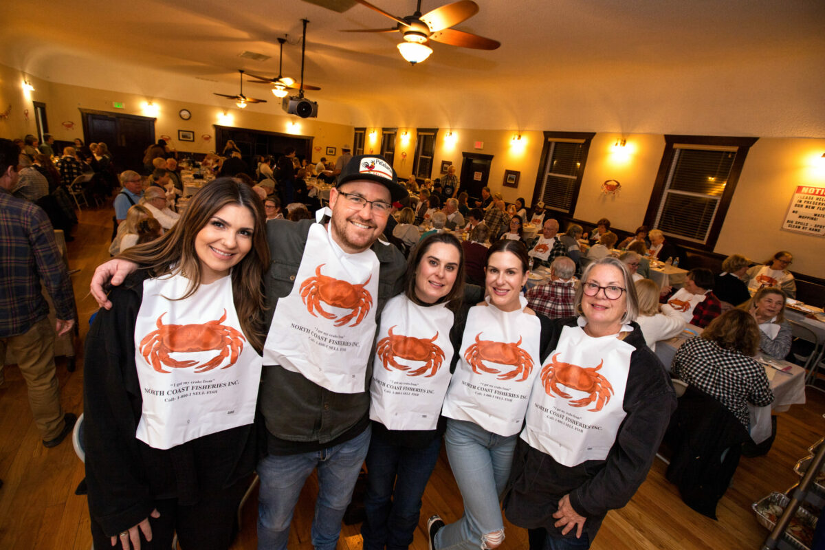 Patrons with their bibs on before dinner, from left, Meghan Grant, Dylan De Jong, with sisters, Kristin Petrides, Megan Petrides, and their mom, Janet Petrides, all of Petaluma, during the Crab Feed Benefit presented by Penngrove Social Firemen at the Penngrove Community Clubhouse, Saturday, Jan. 21, 2023, in Penngrove. (Darryl Bush/For The Press Democrat)