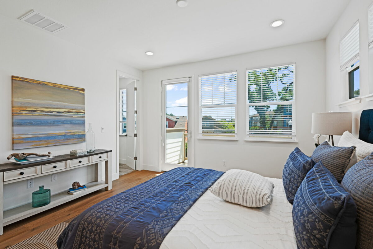 The main bedroom has lots of light thanks to ample windows and a glass-paned door. (ClearShotCreations)