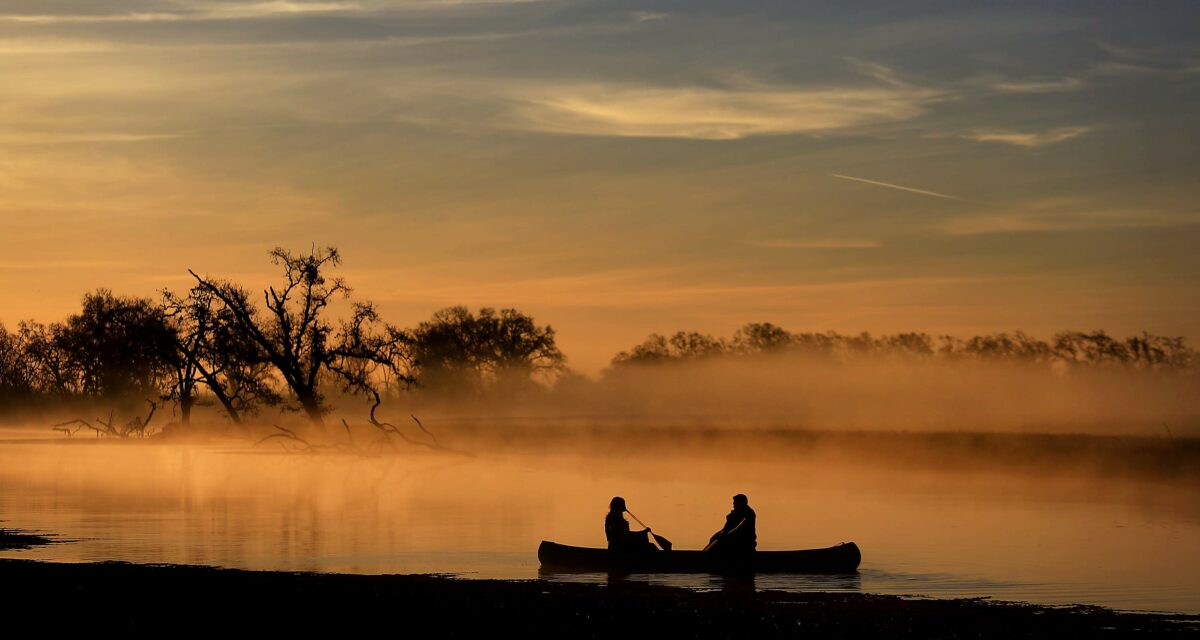 Britney Wehrfritz, left, and Steve Nemecek of Sebastopol paddle a canoe early Friday morning at the Laguna de Santa Rosa. (Kent Porter/The Press Democrat)