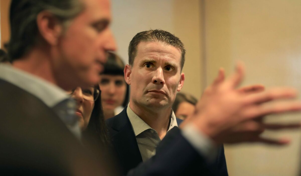 In Middletown, state Sen. Mike McGuire listens as California Gov. Gavin Newsom, Friday, March 22, 2019, announces a plan to help protect California's most wildfire-vulnerable areas. (Kent Porter / The Press Democrat) 