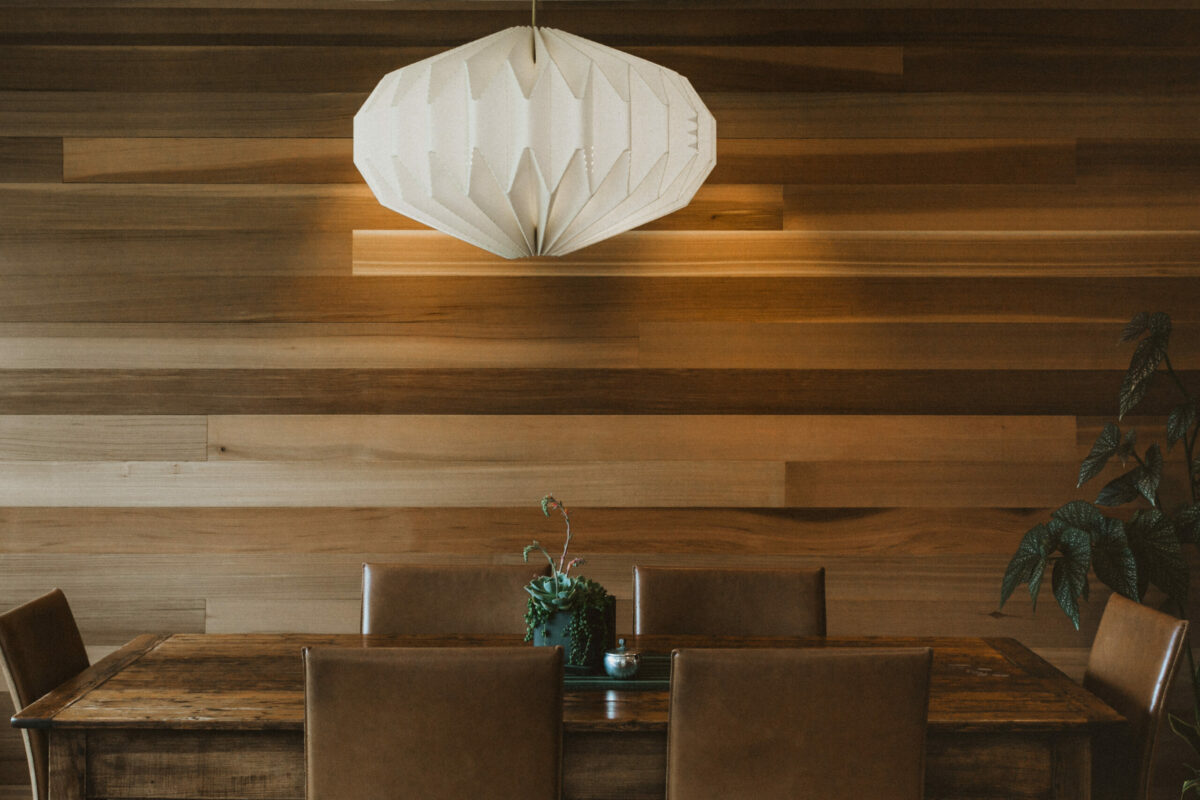 Leather and wood blend beautifully together in this eating area by Zeitgeist Sonoma. With such an earthy base, it just takes deep-green plants and a bright Herman Miller lamp to create stunning contrast. (Tammy Horton Photography)