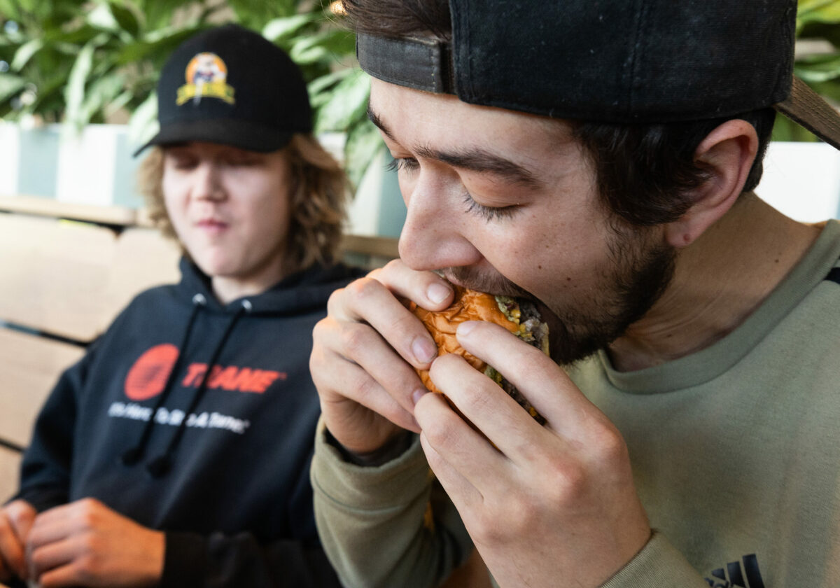 Chris Cordoba digs into a burger during a practice lunch service for friends and family at Shake Shack Santa Rosa’s Montgomery Village Wednesday, February 28, 2024. (Photo by John Burgess/The Press Democrat)