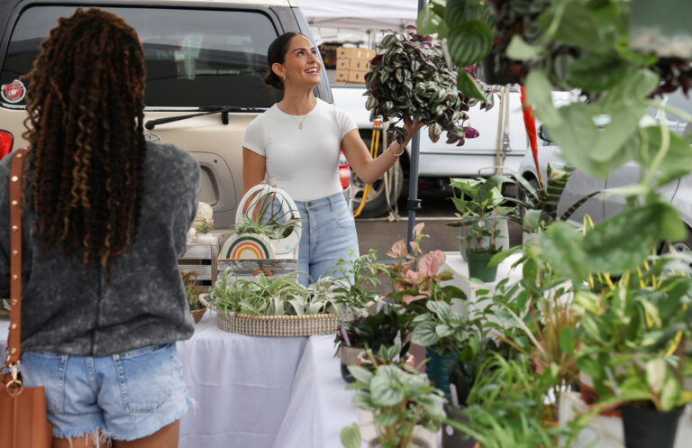 Ana Prado tells a customer about a plant at her Blooming Coast booth at the Santa Rosa Original Certified Farmers Market in Santa Rosa, Wednesday, Aug. 9, 2023. (Christopher Chung / The Press Democrat)