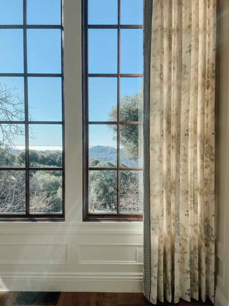 A traditional Healdsburg living room with ornate trims gets a heavily patterned window treatment. But interior designer Stephanie Meyer of AVCO Design keeps the look tranquil by using a tonal colorway. (Courtesy of AVCO Design)