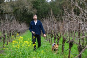 Winemaker Jack Sporer of Magnolia Wine Services and Fres.Co wines, with his pup, Canela. (James Joiner/For Sonoma Magazine)