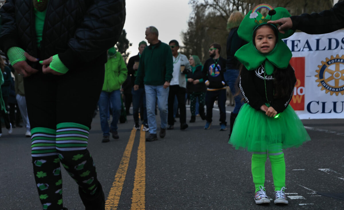 Five year-old McKynze Rose pauses during the Healdsburg's St. Patrick's Day Parade, Friday, March 17, 2023. (Kent Porter / The Press Democrat)