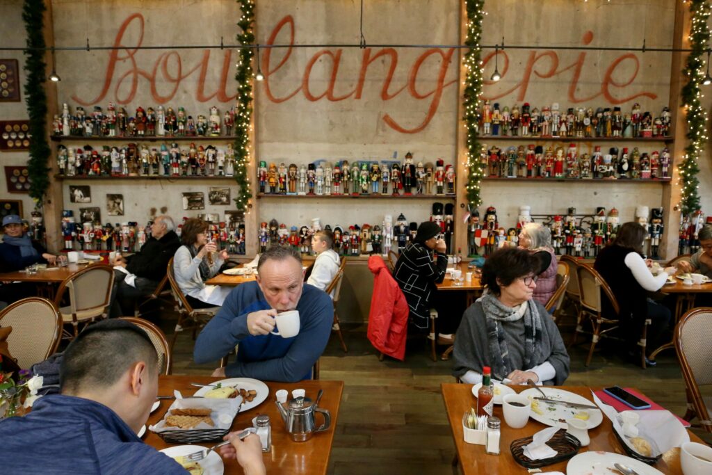 Ken Gompert, left, and Jill Corkern, right, dine at Costeaux's French Bakery in Healdsburg on Tuesday, November 26, 2019. (Beth Schlanker/ The Press Democrat)