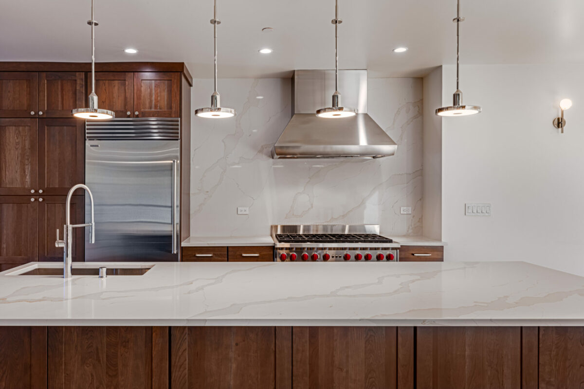 Limiting the number of materials creates a quieter statement. Here a trio of materials—stainless, cherry woods, and quartz—provide a handsome look in this kitchen by Cesar Chavez Design. (Barry Schwarz)